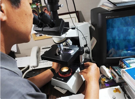 close-up man doing a microscopic examination