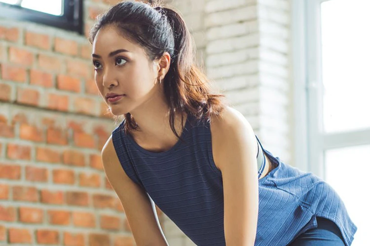 fitness woman in active wear doing exercise at home