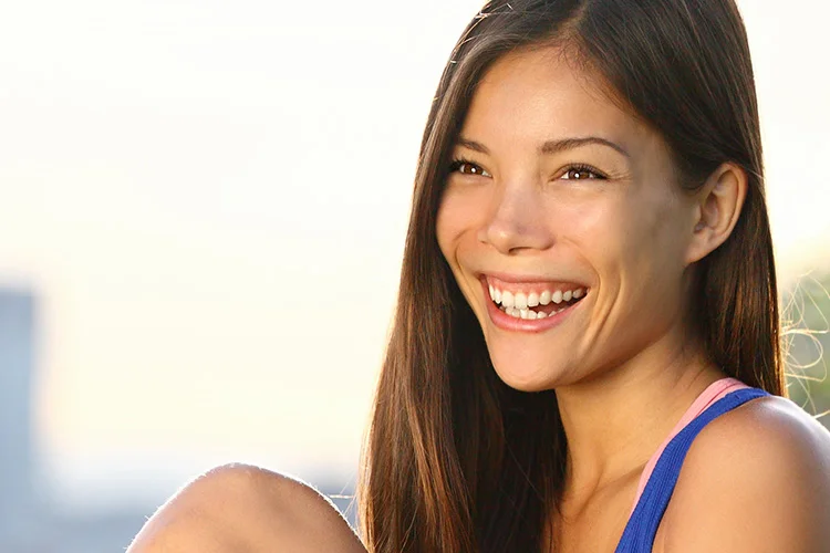 smiling woman with skyline in the background