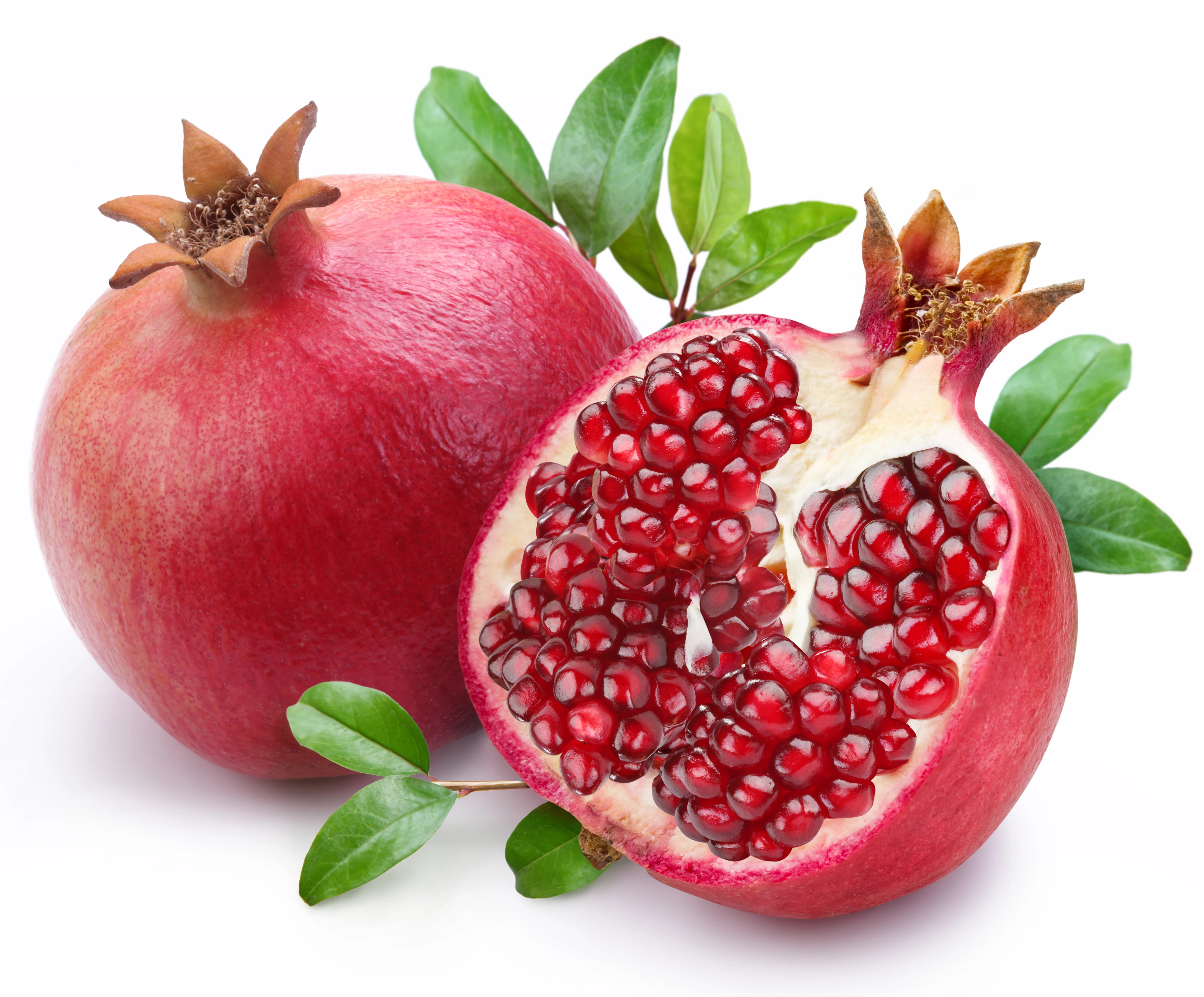 juicy pomegranate and its half with leaves